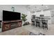 Open concept living area with kitchen island, bar seating and comfortable living room furniture at 311 Pop Top Ln, Daytona Beach, FL 32124