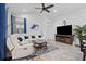 Spacious living room features a large sectional sofa, modern entertainment center, and a ceiling fan at 311 Pop Top Ln, Daytona Beach, FL 32124