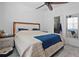 Bright main bedroom with a modern lit headboard, ceiling fan, walk-in shower, and mirrored wall at 311 Pop Top Ln, Daytona Beach, FL 32124