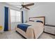 Inviting primary bedroom with large window, ceiling fan, and ensuite bathroom access at 311 Pop Top Ln, Daytona Beach, FL 32124