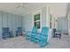 Charming covered porch with rocking chairs and ceiling fan at 311 Pop Top Ln, Daytona Beach, FL 32124