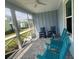 View of the spacious screened porch featuring a ceiling fan and comfortable rocking chairs at 311 Pop Top Ln, Daytona Beach, FL 32124