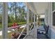 Charming screened porch with comfortable seating and serene views at 311 Pop Top Ln, Daytona Beach, FL 32124