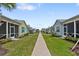Landscaped street view of cottage-style homes, manicured lawns, and sidewalks that invite a walk at 311 Pop Top Ln, Daytona Beach, FL 32124