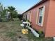 Backyard view showcasing a section of the house's exterior with assorted plantings at 675 Elbridge Dr, Kissimmee, FL 34758