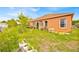 A verdant backyard with lush grass and thriving greenery, offers tranquility and privacy at 675 Elbridge Dr, Kissimmee, FL 34758