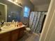 Bathroom featuring a vanity, toilet, and shower with decorative curtain at 675 Elbridge Dr, Kissimmee, FL 34758