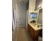 Well-lit bathroom with a vanity, mirror, and tiled floor offering functionality at 675 Elbridge Dr, Kissimmee, FL 34758
