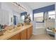 Bright bathroom featuring double sinks and separate tub and shower at 675 Elbridge Dr, Kissimmee, FL 34758