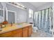 Bathroom featuring a large mirror, vanity with cabinets, and shower/tub combo at 675 Elbridge Dr, Kissimmee, FL 34758