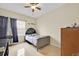 Bright bedroom with tile floors, ceiling fan, and a window with sheer curtains at 675 Elbridge Dr, Kissimmee, FL 34758