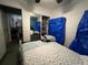 Comfortable bedroom with a closet and blue covers for storage at 675 Elbridge Dr, Kissimmee, FL 34758