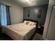 Comfortable bedroom featuring a queen-size bed, warm lighting, and a minimalist decor at 675 Elbridge Dr, Kissimmee, FL 34758
