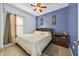 A serene bedroom with soft natural light, soothing blue walls, and comfortable furnishings for relaxation at 675 Elbridge Dr, Kissimmee, FL 34758
