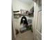 Walk-in closet featuring shelves, storage bins, and hanging clothes at 675 Elbridge Dr, Kissimmee, FL 34758