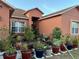 Home entrance with lots of colorful potted plants and flowers in the garden at 675 Elbridge Dr, Kissimmee, FL 34758