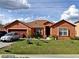 Charming single-story home with well-maintained lawn and two-car garage at 675 Elbridge Dr, Kissimmee, FL 34758
