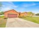 Inviting single-Gathering home with a vibrant lawn and mature landscaping, creating an appealing curb presence at 675 Elbridge Dr, Kissimmee, FL 34758
