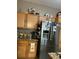 Kitchen with wooden cabinets and stainless steel refrigerator at 675 Elbridge Dr, Kissimmee, FL 34758