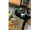 Kitchen with wooden cabinets, granite counter and stainless steel oven at 675 Elbridge Dr, Kissimmee, FL 34758