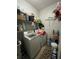 Compact laundry room with a washer, dryer, and organized shelving for storage at 675 Elbridge Dr, Kissimmee, FL 34758