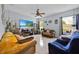 Comfortable living room featuring sofas, a ceiling fan and a large TV at 675 Elbridge Dr, Kissimmee, FL 34758
