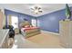 Spacious main bedroom features a ceiling fan and large windows for natural light at 675 Elbridge Dr, Kissimmee, FL 34758