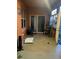 An enclosed patio with black chairs, plants, and multiple windows at 675 Elbridge Dr, Kissimmee, FL 34758