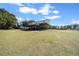 Exterior shot of horse barn with metal roof, surrounded by grassy field at 2198 W Highway 329, Citra, FL 32113