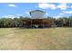 Exterior shot of horse barn and paddocks, surrounded by grassy field at 2198 W Highway 329, Citra, FL 32113