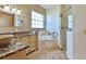 Bathroom features dual sinks, marble countertops, jacuzzi tub, and glass-enclosed shower at 2198 W Highway 329, Citra, FL 32113