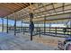 View of a horse barn showing stalls with wood shavings, posts, and metal roof at 2198 W Highway 329, Citra, FL 32113