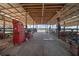 View down the center of the horse barn, showing stalls on either side at 2198 W Highway 329, Citra, FL 32113