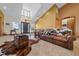 Spacious living room featuring a high ceiling, a large leather couch, and unique western-themed decor at 2198 W Highway 329, Citra, FL 32113