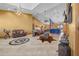 Expansive living room featuring high ceilings, tile flooring, leather sofas, and an open layout with a partial view of the kitchen at 2198 W Highway 329, Citra, FL 32113