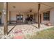 Covered patio featuring patterned tile flooring, wooden support beams, and vintage carriage decor at 2198 W Highway 329, Citra, FL 32113