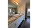 Bathroom with marble countertops, dual sinks, and a walk-in shower with glass doors at 6711 Sw 64Th Ave, Ocala, FL 34476
