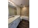 Bathroom featuring a stylish vanity, modern lighting, and a shower-tub combination with a tiled surround at 6711 Sw 64Th Ave, Ocala, FL 34476