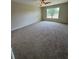 Spacious carpeted bedroom with a ceiling fan and a window providing ample light at 6711 Sw 64Th Ave, Ocala, FL 34476