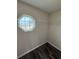 Small walk-in closet featuring laminate floor, a frosted octagonal window, and wire shelving at 6711 Sw 64Th Ave, Ocala, FL 34476