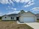 Charming single-story home with a two-car garage, well-maintained lawn, and inviting entrance at 6711 Sw 64Th Ave, Ocala, FL 34476
