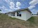 Bright single-story home featuring neutral stucco and large windows overlooking the spacious yard at 6711 Sw 64Th Ave, Ocala, FL 34476