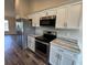 Updated kitchen featuring stainless steel appliances and light countertops with white cabinets at 6711 Sw 64Th Ave, Ocala, FL 34476