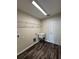 Laundry room with sink, shelving, and new plank flooring at 6711 Sw 64Th Ave, Ocala, FL 34476