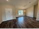 Living room featuring dark wood vinyl flooring, natural light and a modern chandelier at 6711 Sw 64Th Ave, Ocala, FL 34476
