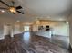 Open-concept living space featuring sleek flooring, a modern kitchen island, and ample natural light at 6711 Sw 64Th Ave, Ocala, FL 34476