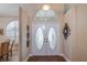 Inviting foyer features a double door entry with decorative glass and bright sidelight windows at 10411 Sw 52Nd Ct, Ocala, FL 34476