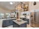 Spacious kitchen with modern appliances, kitchen island, granite countertops, and stylish lighting at 10411 Sw 52Nd Ct, Ocala, FL 34476