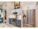 Elegant kitchen featuring white cabinets, stainless steel appliances, and marble backsplash at 10411 Sw 52Nd Ct, Ocala, FL 34476