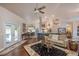 Cozy living room with hardwood floors, ceiling fan, stylish rug, and easy access to the kitchen at 10411 Sw 52Nd Ct, Ocala, FL 34476